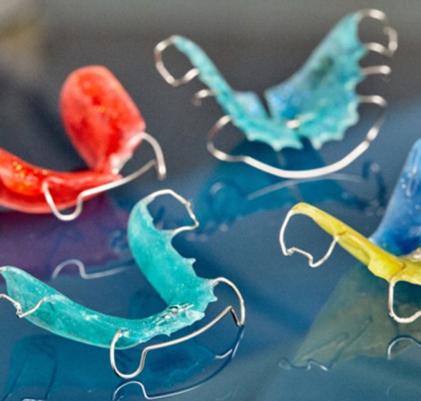 Closeup of four differently colorful retainers