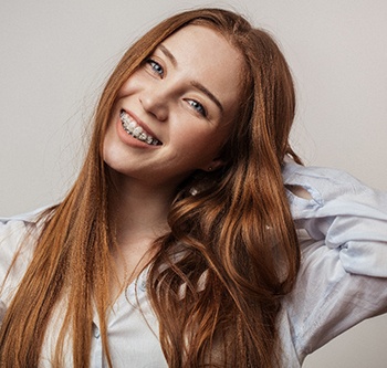 Woman smiling with clear braces