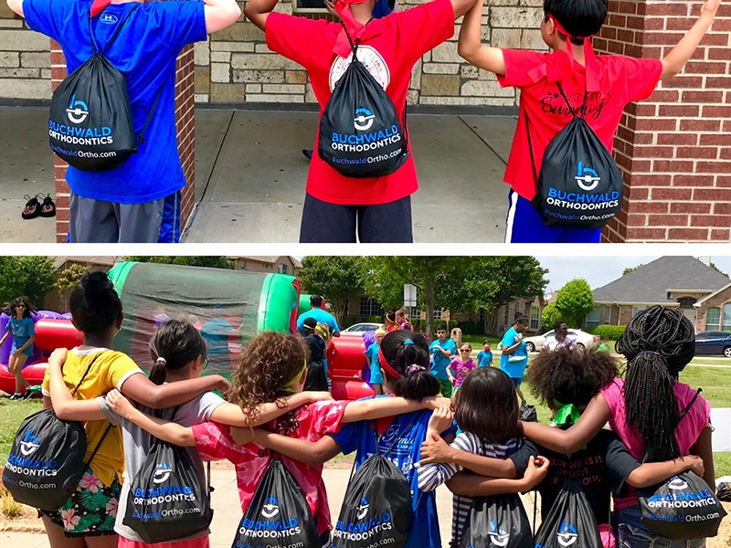 Class of kids wearing Buchwald Orthodontics drawstring bags