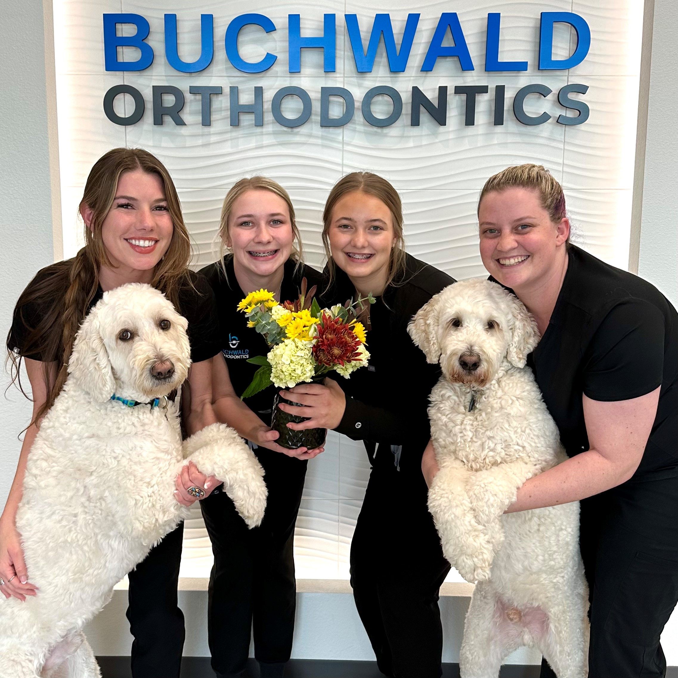 Four smiling Buchwald Orthodontic team members