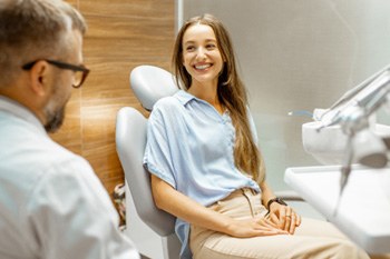 Female patient smiling at dentist at dental appointment