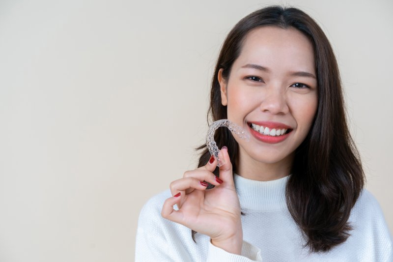 person holding Invisalign