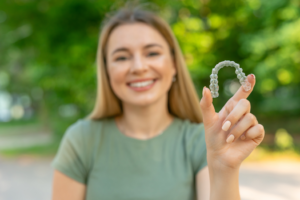 a patient holding their Invisalign aligner